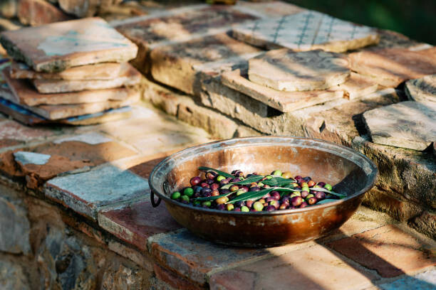 Plakát Olive fruits in container kept on paving stones