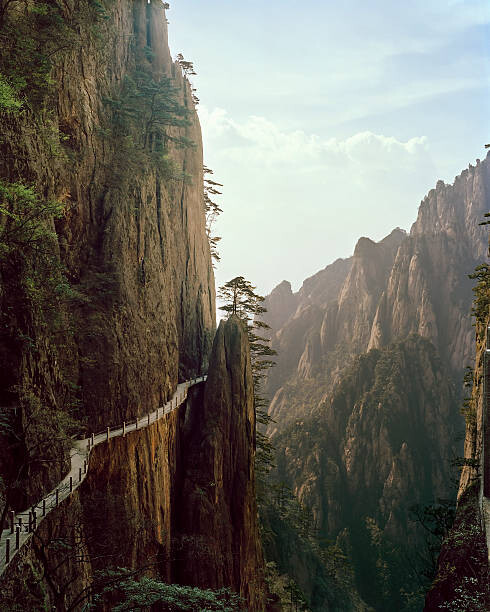 Plakát Pathway winding through Chinese mountian landscape