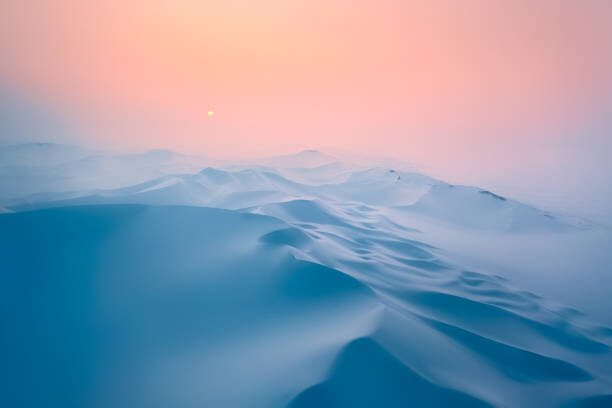 Plakát Snow covered desert sand dunes at sunset in winter