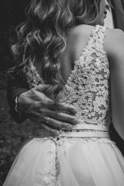 Plakát The bride and groom hugging. Ring on grooms hand.