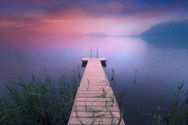 Plakat Wooden pier. Midsummer lake at evening in Finland