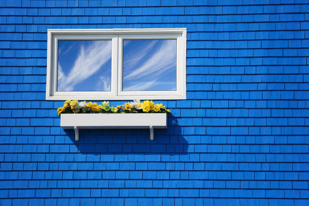 Obraz na płótnie A window on a blue wall.