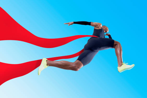 Obraz na płótnie Athlete running through red ribbon
