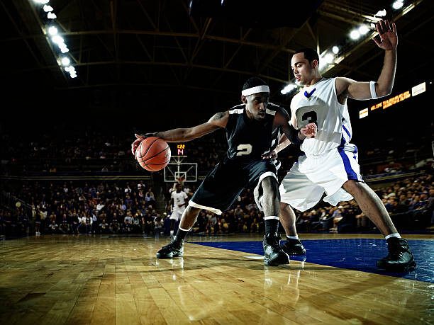 Obraz na płótnie Basketball player being guarded by defender