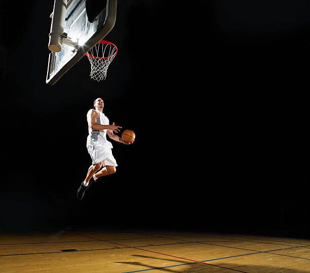 Obraz na płótnie Basketball player slam dunking ball