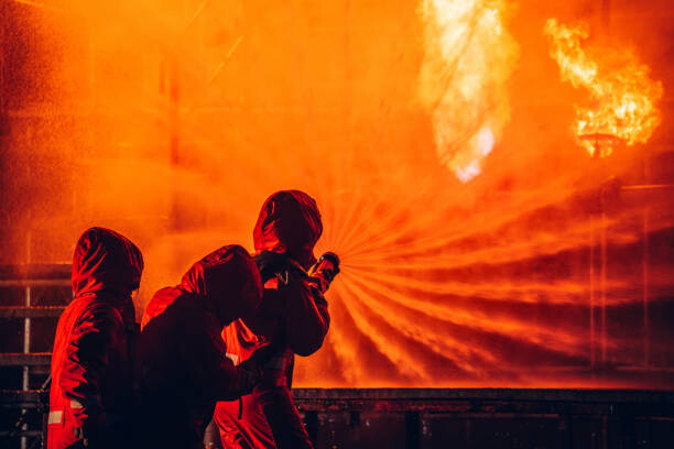 Obraz na płótnie Firefighters Battling Blaze with Water