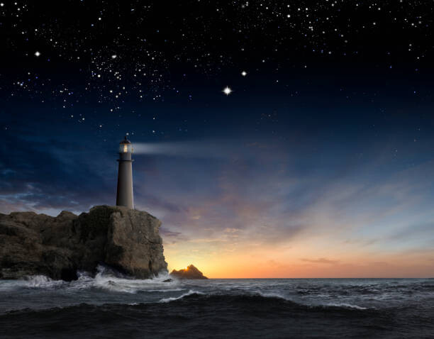 Obraz na płótnie Lighthouse beaming over rocky ocean waves