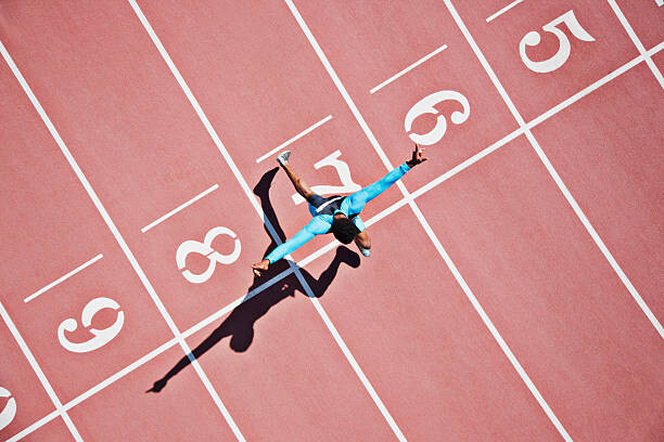 Obraz na płótnie Runner crossing finishing line on track