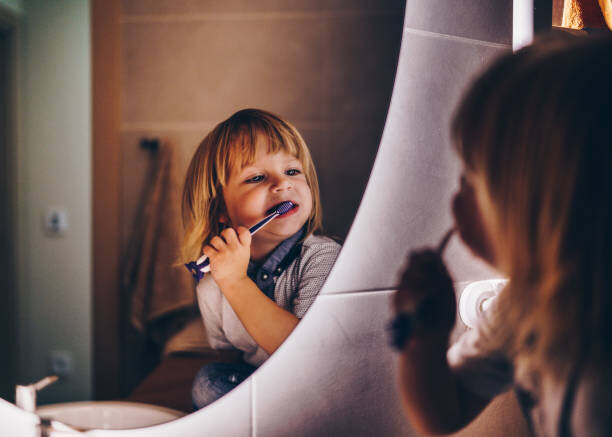 Obraz na płótnie sweet young boy is brushing teeth