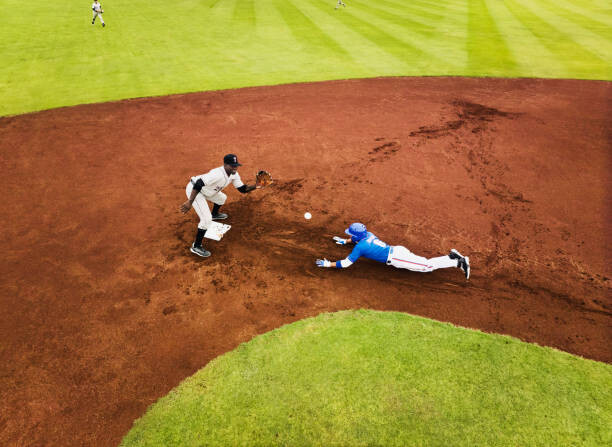 Obraz na płótnie Wide shot runner sliding into second