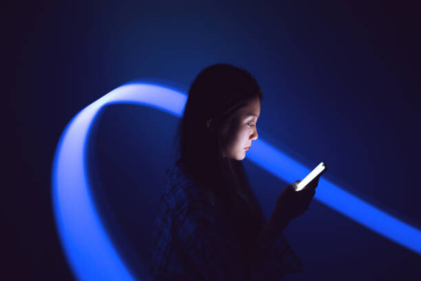 Obraz na płótnie Young Asian woman using smartphone on