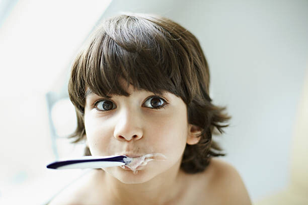 T-Shirt Portrait of boy (7-9) brushing teeth