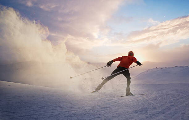 Poster A cross country skier at sunset in Norway