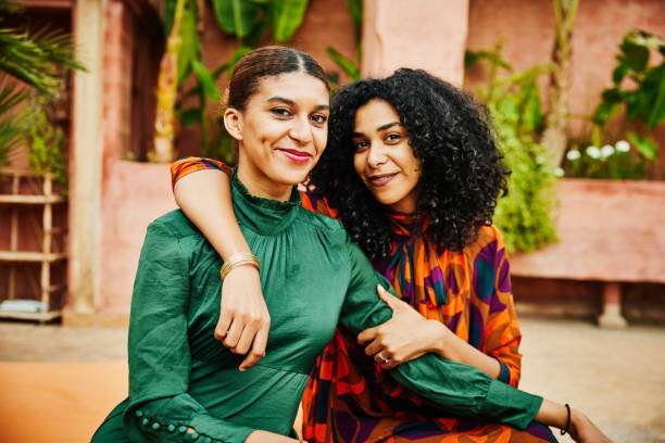 Poster Medium shot of smiling embracing sisters
