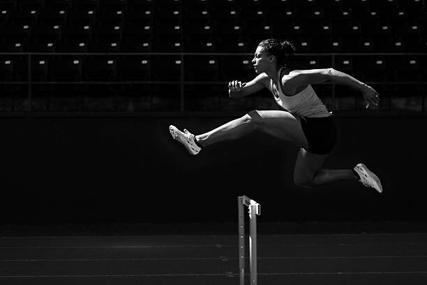 Poster A runner taking on the hurdles.