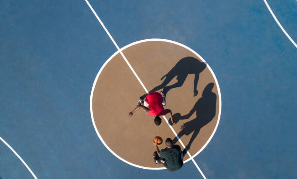 Poster Aerial shot of 2 basketball players and shadows