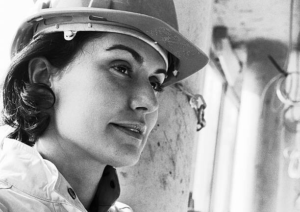 Poster Woman wearing hard hat, close-up, b&w