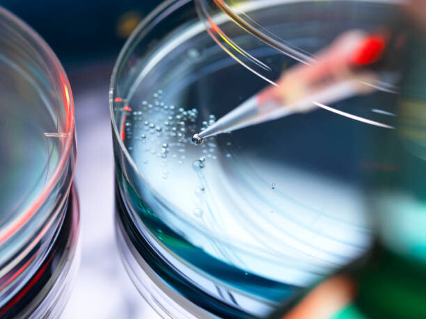 Sticker Stem Cell Research, Scientist pipetting cells