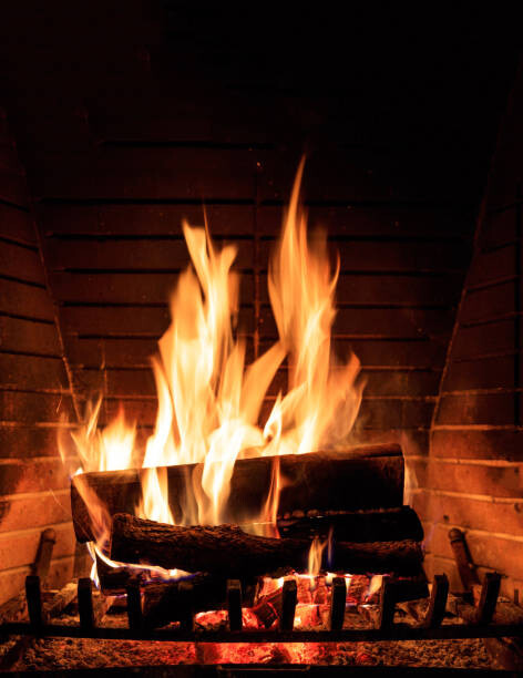 Tablou pe pânză Fireplace burning wood logs, cozy warm home christmas time