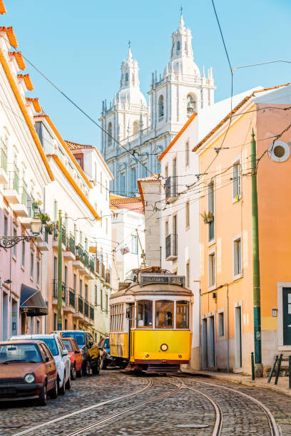 Tablou pe pânză Yellow tram on the narrow street