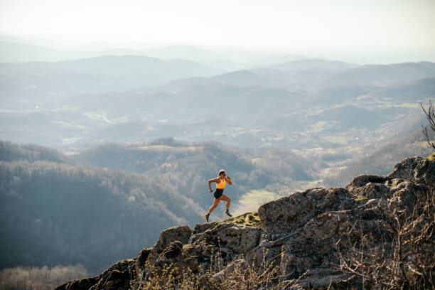 Tableau sur toile Woman running on mountain