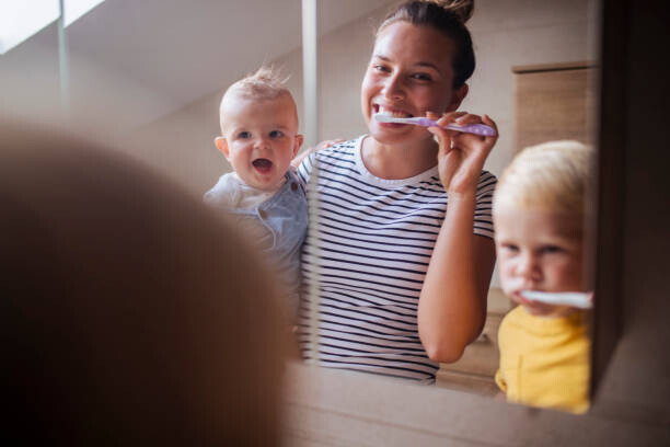 T-Shirt While the mother holds the baby