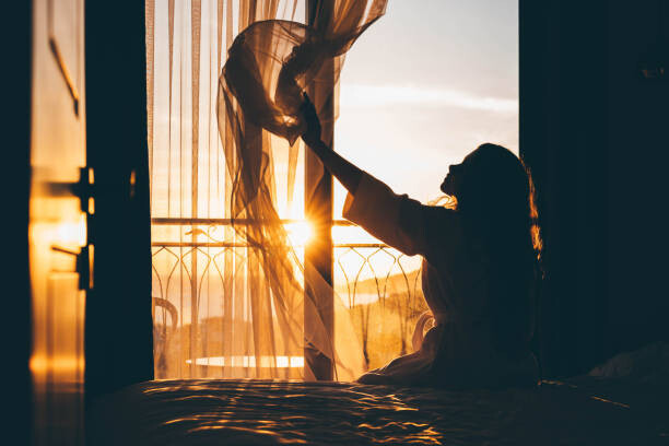Samolepka Woman opens curtain to enjoy view