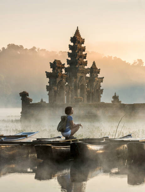 Samolepka young Asian woman sitting on boat