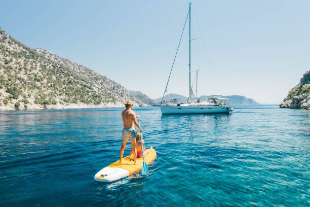 Samolepka Young couple paddling on stand up