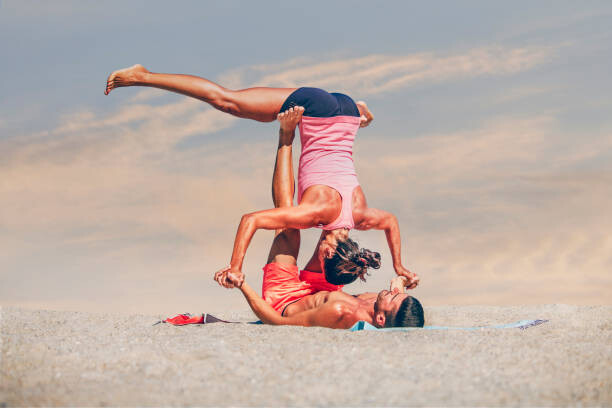 Autocolant Young sporty couple practicing acroyoga exercises