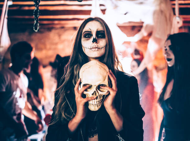 Tričko Young woman with skeleton make-up holding
